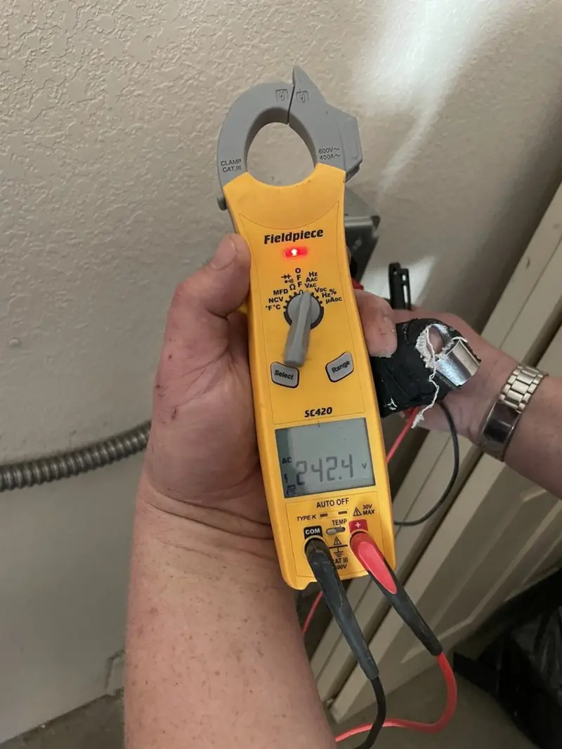 Voltage testing with clamp meter during Ceiling Fan Installation in Southold